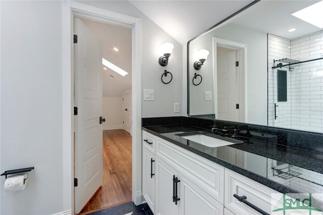 bathroom with vanity, wood-type flooring, and a shower with door