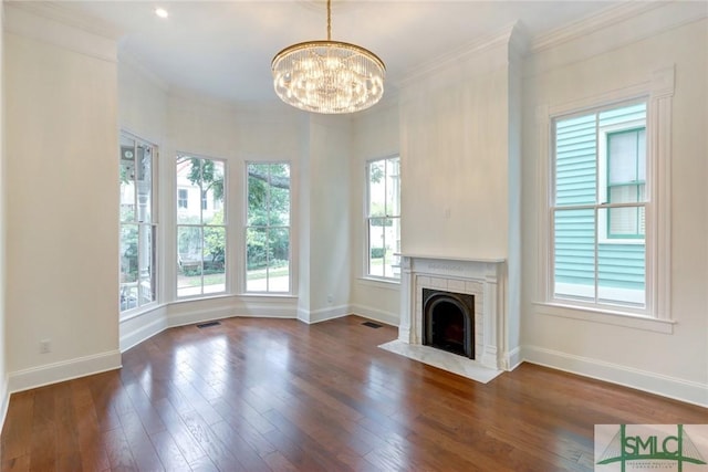 unfurnished living room featuring a notable chandelier, dark hardwood / wood-style floors, and crown molding