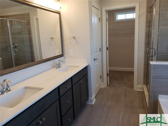 bathroom with an enclosed shower, crown molding, and vanity