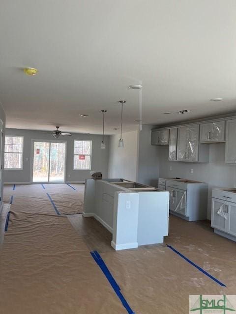 kitchen with pendant lighting, ceiling fan, plenty of natural light, and gray cabinets