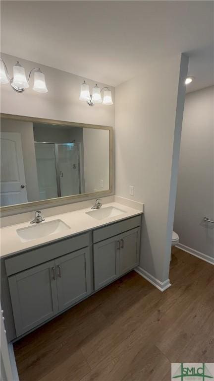 20 Flagler Dr, Savannah, GA 31419 - full bathroom featuring a stall shower, double vanity, a sink, and wood finished floors
