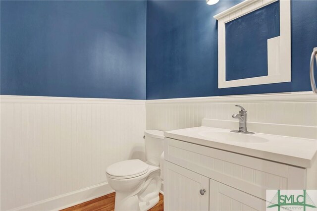 bathroom featuring hardwood / wood-style flooring, vanity, and toilet