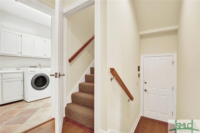 laundry room with cabinets, washer / clothes dryer, and light hardwood / wood-style flooring