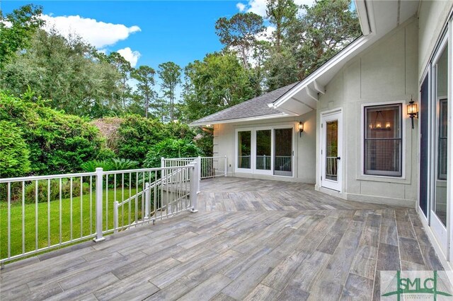 wooden deck with a lawn