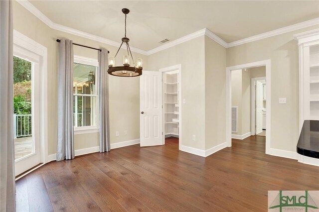 unfurnished dining area with a notable chandelier, dark hardwood / wood-style flooring, and ornamental molding