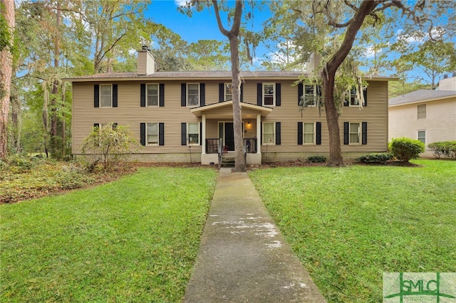 colonial-style house with a front lawn