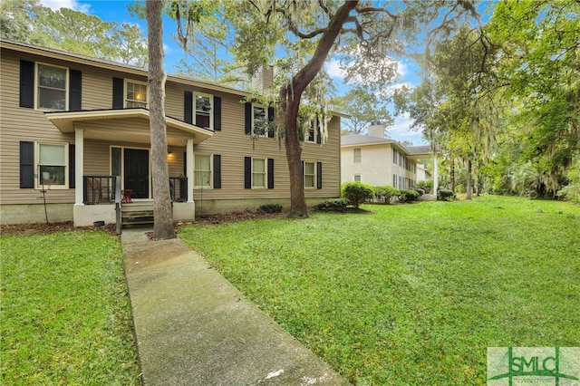 view of front of property with a porch and a front yard