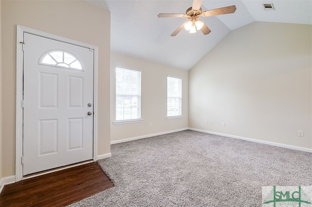 carpeted foyer entrance with lofted ceiling and ceiling fan