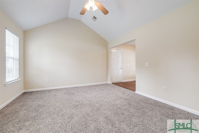 spare room with ceiling fan, carpet flooring, and vaulted ceiling