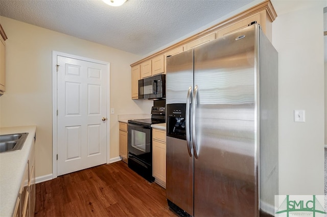 kitchen with a textured ceiling, dark hardwood / wood-style floors, sink, and black appliances