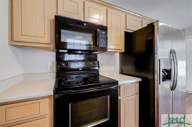 kitchen featuring light brown cabinets and black appliances