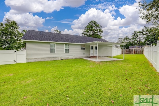 back of property with a lawn and a patio area