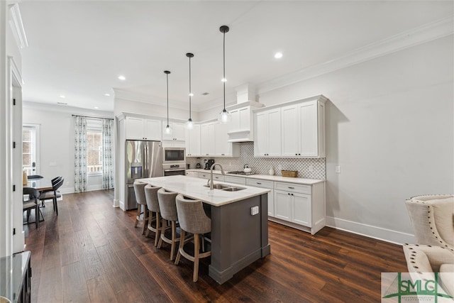 kitchen featuring pendant lighting, sink, dark wood-type flooring, and white cabinetry