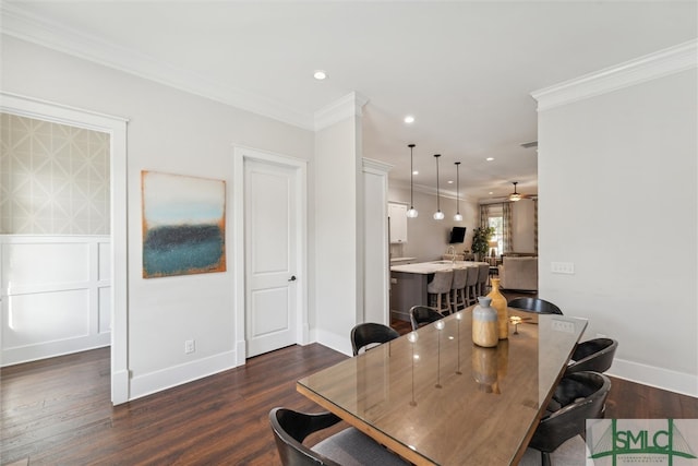 dining room featuring dark wood-type flooring, ornamental molding, and ceiling fan