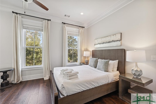 bedroom with ceiling fan, crown molding, and dark hardwood / wood-style flooring