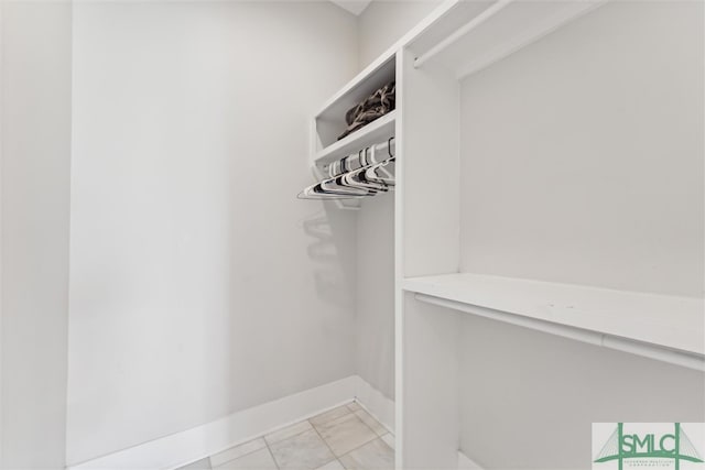 spacious closet with light tile patterned flooring