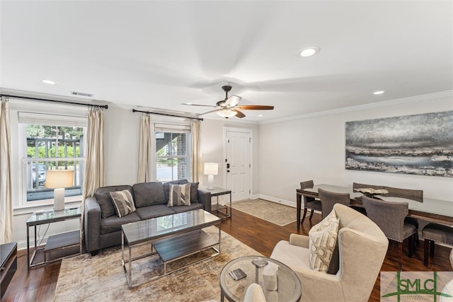 living room with ornamental molding, dark hardwood / wood-style flooring, and ceiling fan