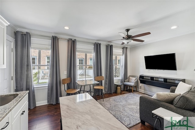 living room featuring ornamental molding, dark hardwood / wood-style flooring, and ceiling fan