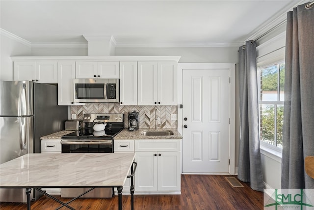 kitchen featuring appliances with stainless steel finishes, sink, and white cabinetry