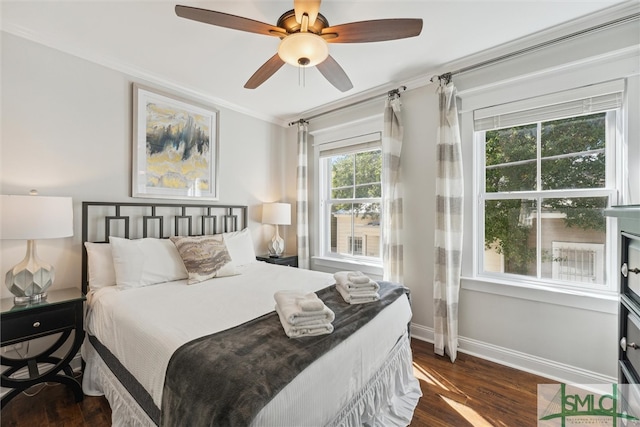 bedroom with dark hardwood / wood-style floors, ornamental molding, and ceiling fan