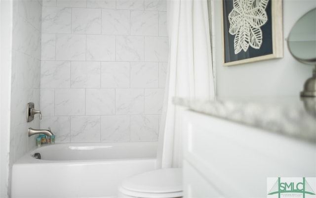 bathroom featuring shower / bath combo with shower curtain and toilet