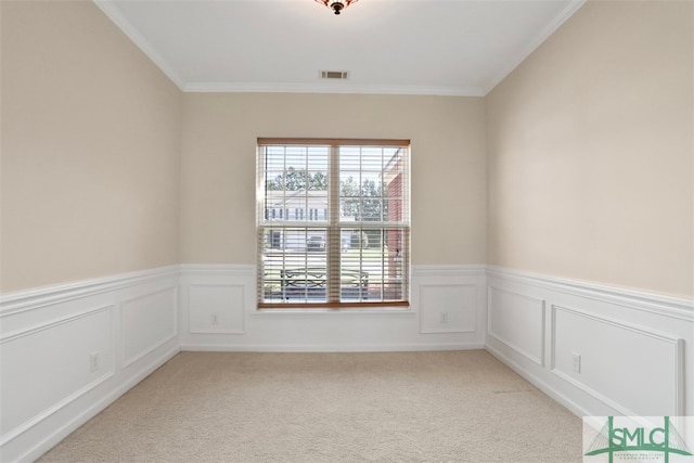 spare room with light carpet and crown molding