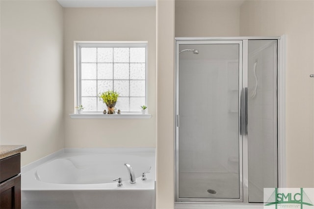 bathroom featuring vanity and plus walk in shower