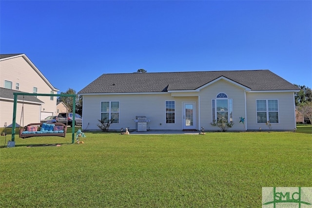 back of property with a patio and a yard