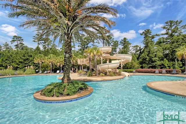 view of swimming pool with a water slide