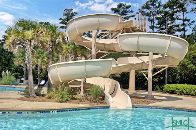 view of swimming pool featuring a water slide