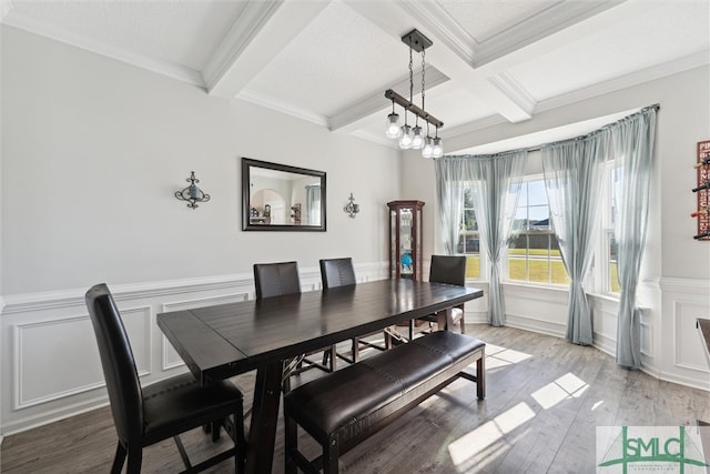 dining area with crown molding, beamed ceiling, and light wood-type flooring