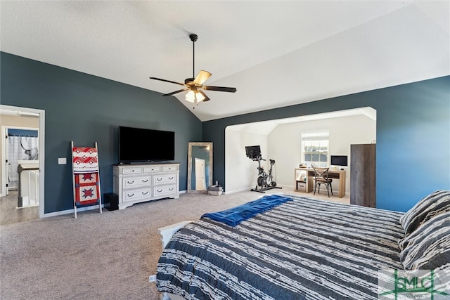 bedroom with ceiling fan, carpet floors, lofted ceiling, and connected bathroom