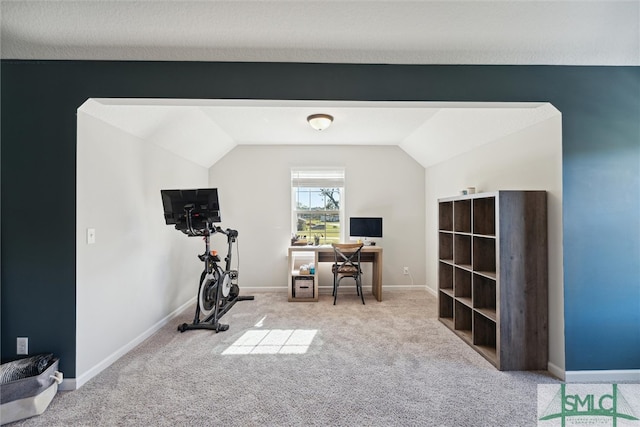 exercise area with light carpet and vaulted ceiling