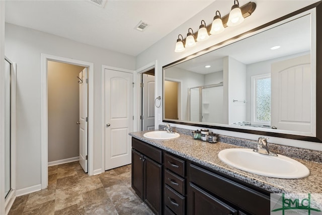 bathroom featuring walk in shower and vanity