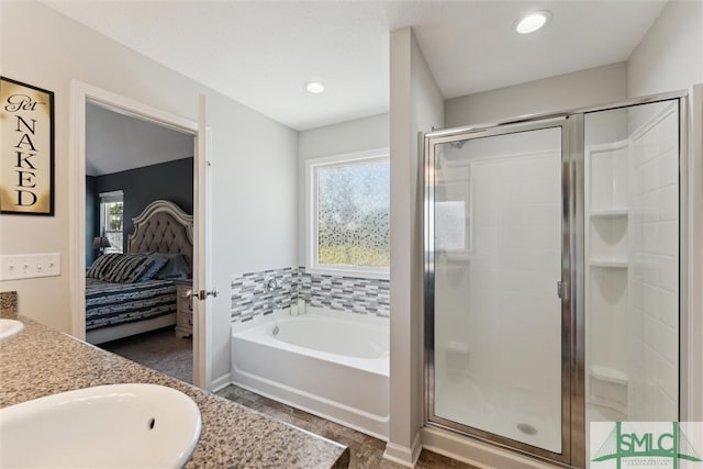 bathroom with vanity, shower with separate bathtub, and plenty of natural light