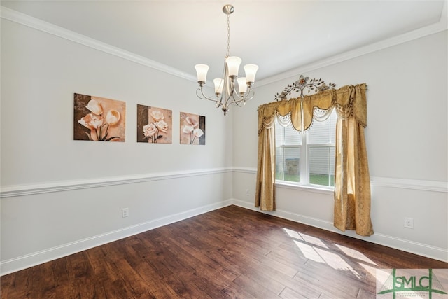 unfurnished room with ornamental molding, an inviting chandelier, and dark hardwood / wood-style flooring