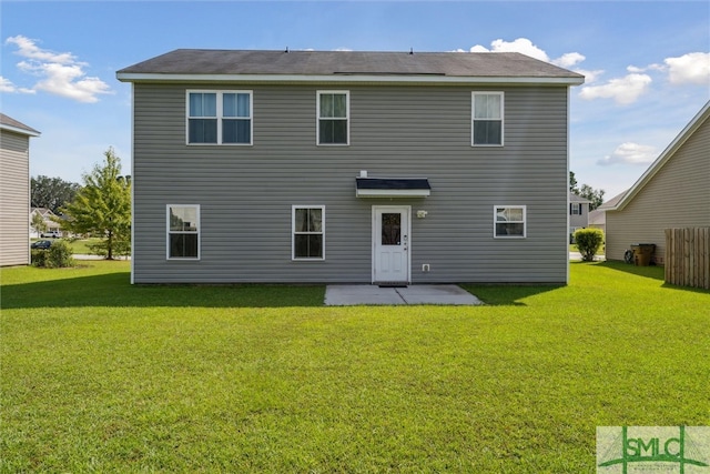 back of house with a yard and a patio area