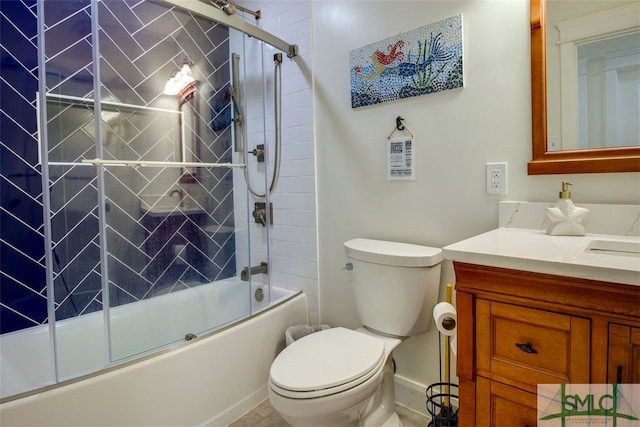 full bathroom featuring tile patterned flooring, combined bath / shower with glass door, vanity, and toilet