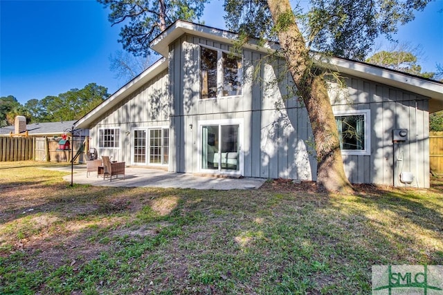 back of house featuring a yard and a patio area