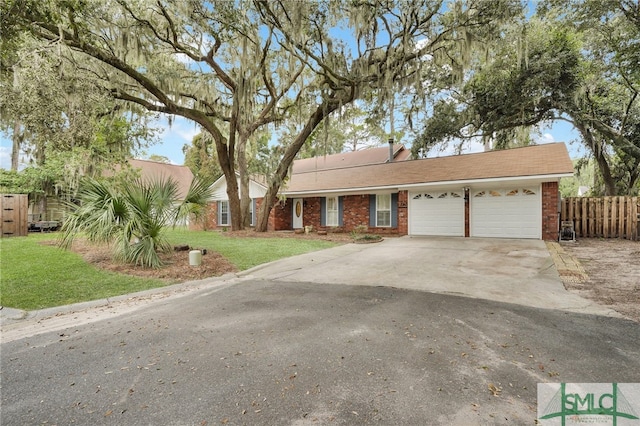 single story home with a front yard and a garage