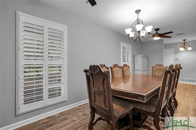 dining area featuring ceiling fan with notable chandelier and hardwood / wood-style floors