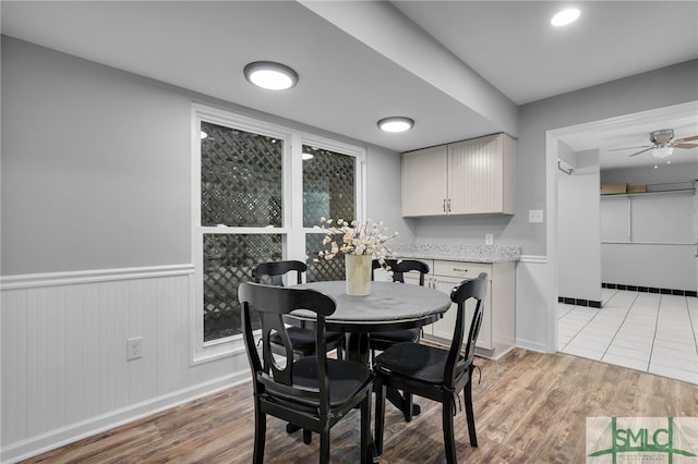 dining room featuring ceiling fan and light hardwood / wood-style flooring