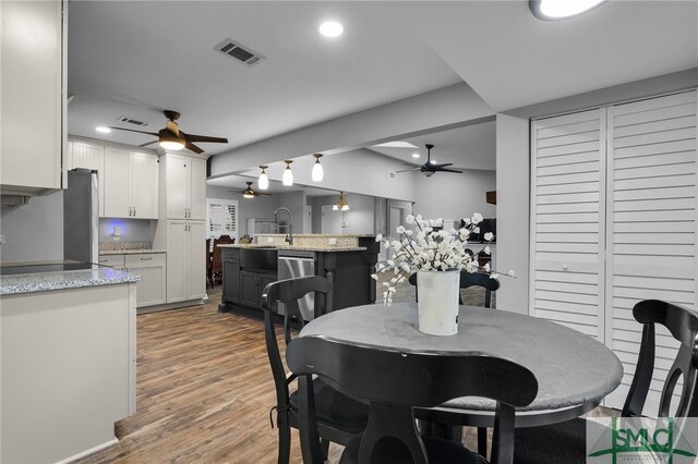 dining room with hardwood / wood-style flooring and sink