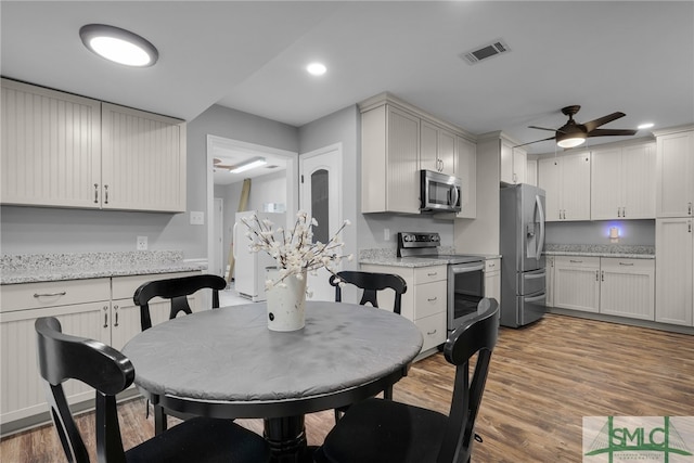 dining room with hardwood / wood-style flooring and ceiling fan