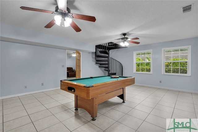 recreation room with ceiling fan, light tile patterned flooring, pool table, and a textured ceiling