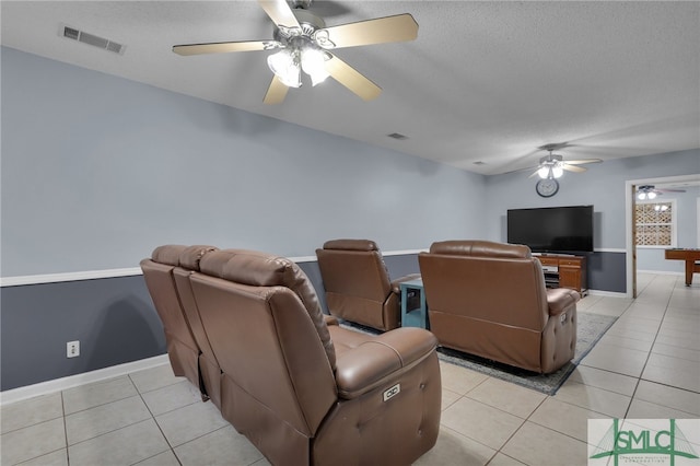 cinema room featuring a textured ceiling, pool table, light tile patterned floors, and ceiling fan