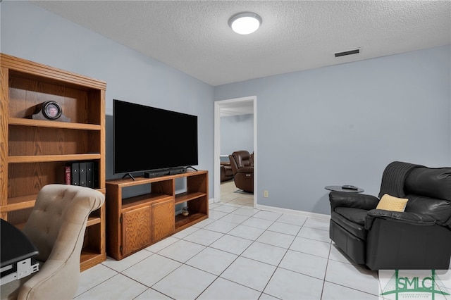 living room featuring light tile patterned floors and a textured ceiling