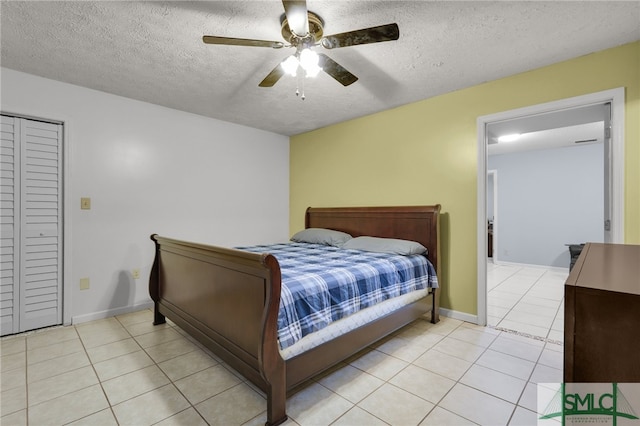 bedroom with ceiling fan, a textured ceiling, and light tile patterned flooring