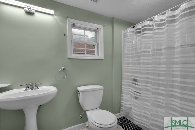 bathroom with sink, tile patterned floors, toilet, and a shower with shower curtain