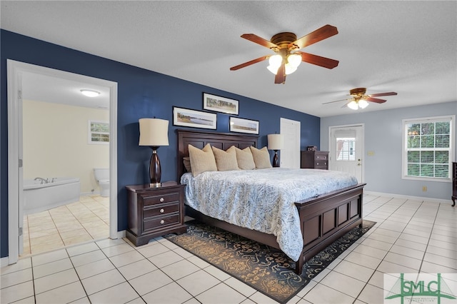 bedroom with light tile patterned floors, connected bathroom, a textured ceiling, and ceiling fan